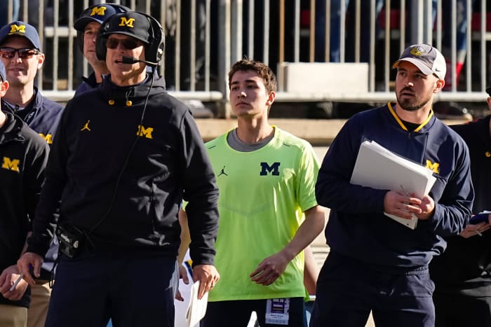 Michigan Wolverines head coach Jim Harbaugh watches from the sideline beside off-field analyst Connor Stalions, right, during the NCAA football game against the Ohio State Buckeyes at Ohio Stadium